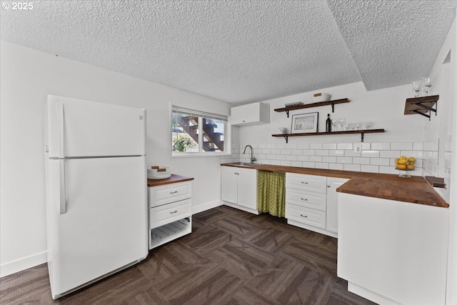 1941 NE 143rd Ave, Portland, OR 97230 - kitchen featuring freestanding refrigerator, butcher block countertops, open shelves, a textured ceiling, and tasteful backsplash