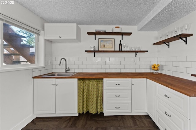 1941 NE 143rd Ave, Portland, OR 97230 - kitchen featuring open shelves, butcher block counters, a textured ceiling, and white cabinets
