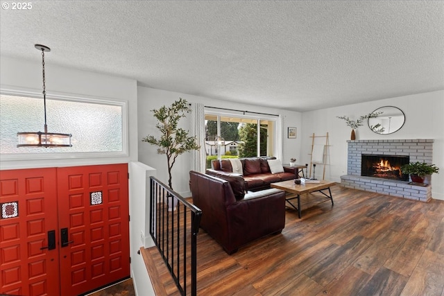 1941 NE 143rd Ave, Portland, OR 97230 - living room with dark wood-style flooring, a textured ceiling, a fireplace, and a chandelier