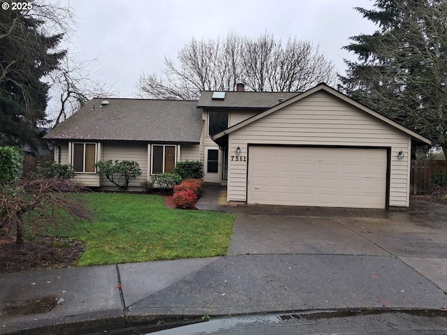 view of front of house with a garage and a front lawn