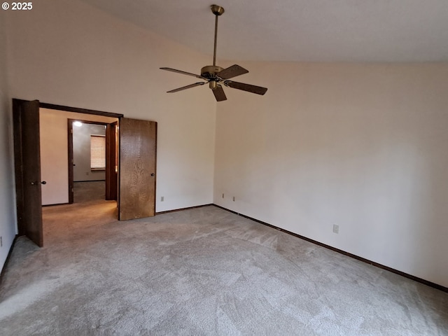 unfurnished bedroom featuring ceiling fan, light colored carpet, and vaulted ceiling