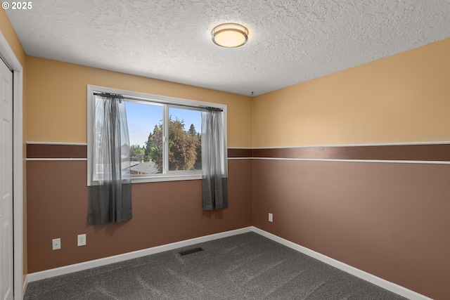 818 Chehalis Pl, Keizer, OR 97303 - unfurnished room featuring a textured ceiling, baseboards, and dark carpet