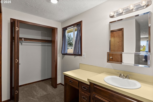 818 Chehalis Pl, Keizer, OR 97303 - bathroom featuring a textured ceiling, vanity, and baseboards