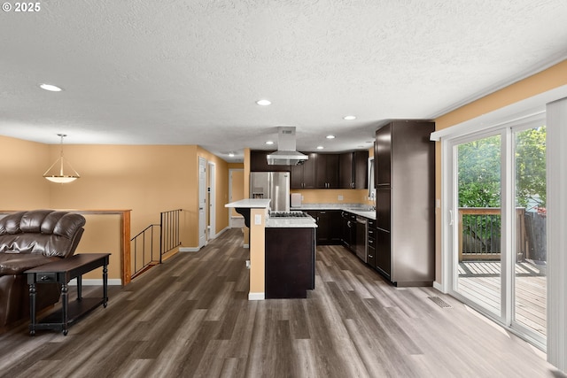 818 Chehalis Pl, Keizer, OR 97303 - kitchen with stainless steel appliances, island exhaust hood, dark wood-type flooring, light countertops, and a textured ceiling