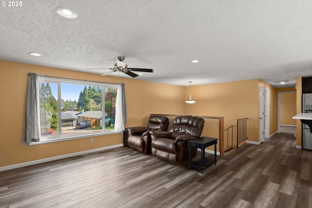 818 Chehalis Pl, Keizer, OR 97303 - living room featuring dark wood-style floors, a textured ceiling, baseboards, ceiling fan, and recessed lighting