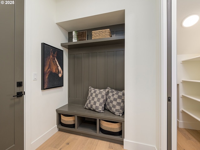 mudroom featuring baseboards and light wood finished floors