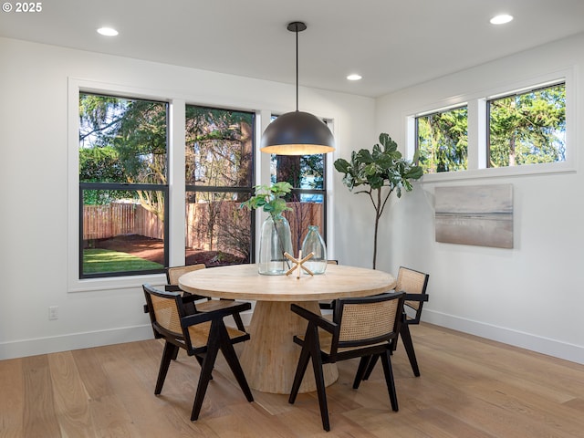 dining space with light wood-style flooring, recessed lighting, and baseboards