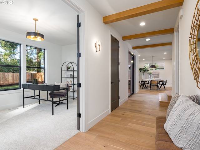 corridor featuring recessed lighting, beamed ceiling, baseboards, and light wood-style flooring