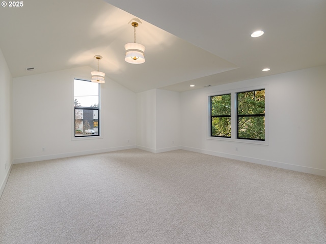 unfurnished room featuring recessed lighting, lofted ceiling, light colored carpet, and a healthy amount of sunlight