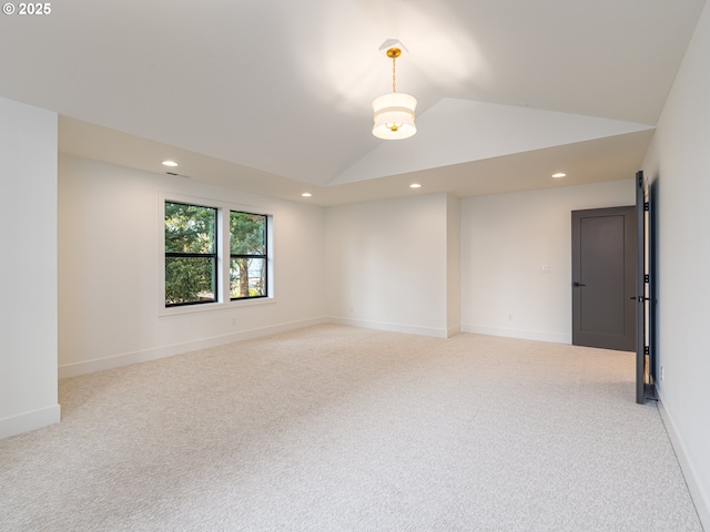 spare room with light carpet, recessed lighting, baseboards, and vaulted ceiling