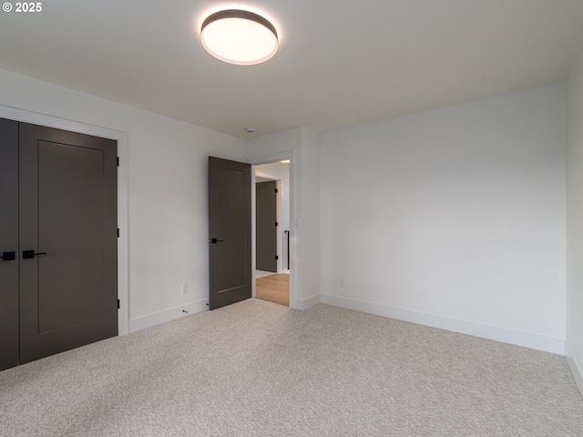 unfurnished bedroom featuring baseboards and carpet floors