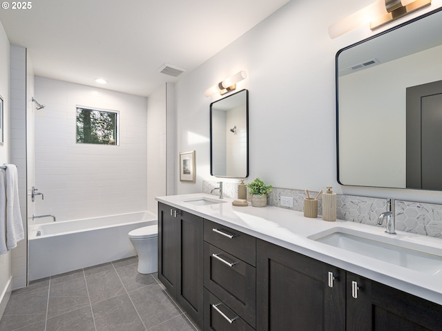 bathroom featuring washtub / shower combination, visible vents, and a sink