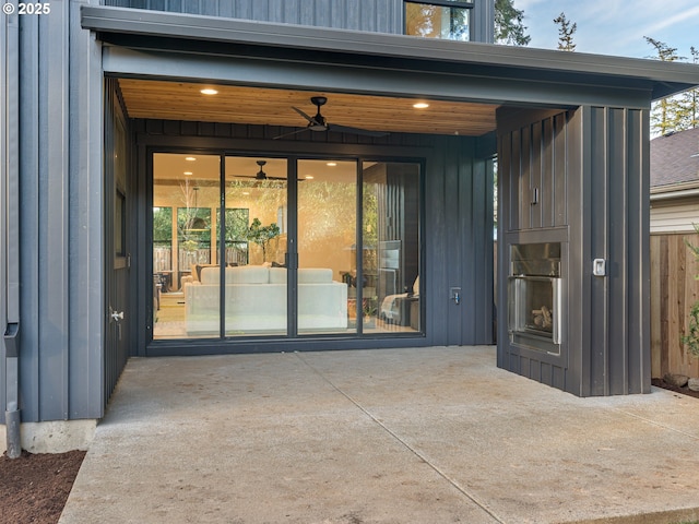 doorway to property with a patio area and board and batten siding