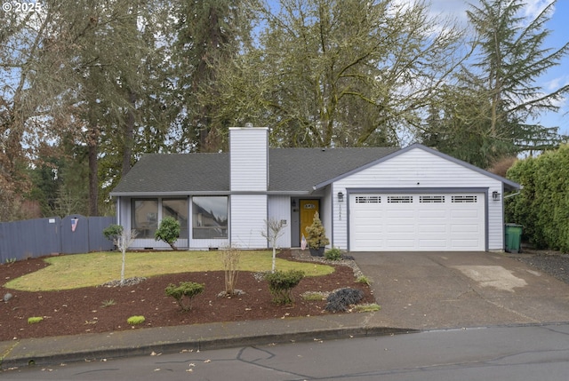 view of front of home with fence, driveway, a chimney, a front lawn, and a garage