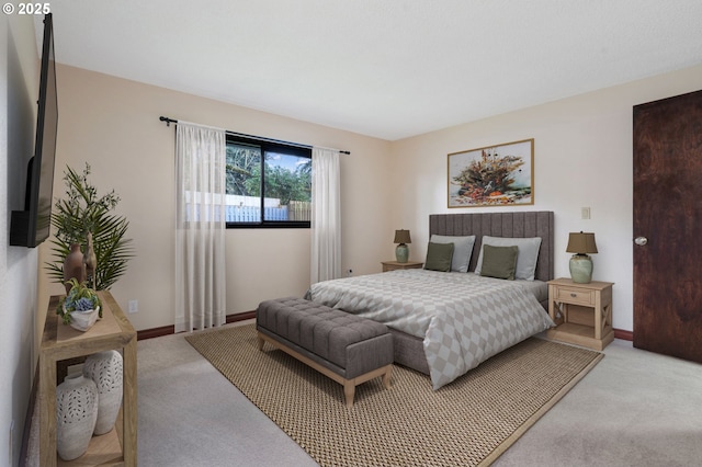 bedroom with light carpet and baseboards