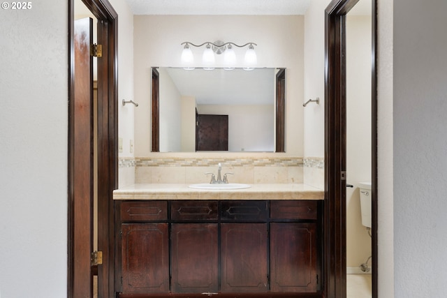 bathroom featuring vanity and tasteful backsplash