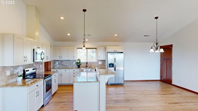 kitchen with a sink, light wood finished floors, a center island, stainless steel appliances, and white cabinets