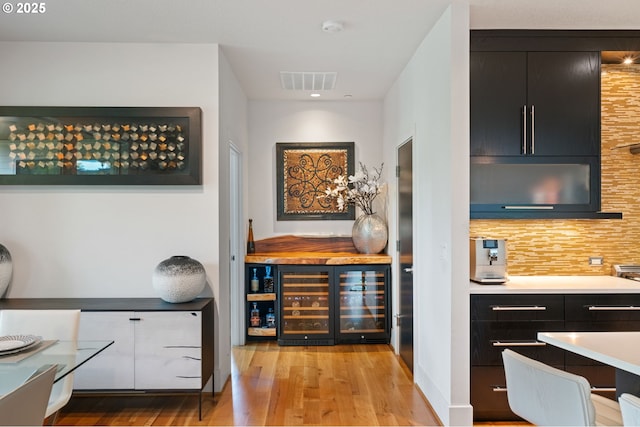 1311 NW 5th Ave, Camas, WA 98607 - bar area featuring wine cooler, wood finished floors, and decorative backsplash