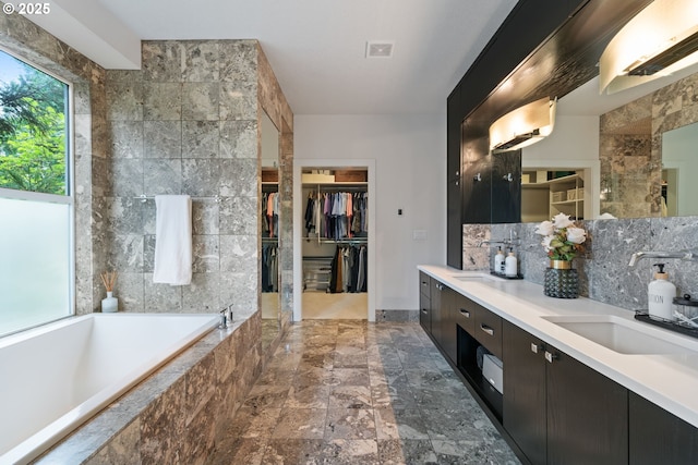 1311 NW 5th Ave, Camas, WA 98607 - bathroom with double vanity, a garden tub, a spacious closet, and backsplash