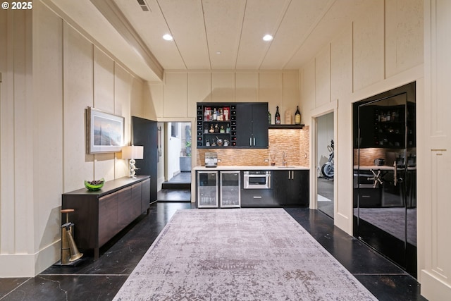 1311 NW 5th Ave, Camas, WA 98607 - indoor bar featuring wine cooler, recessed lighting, and decorative backsplash