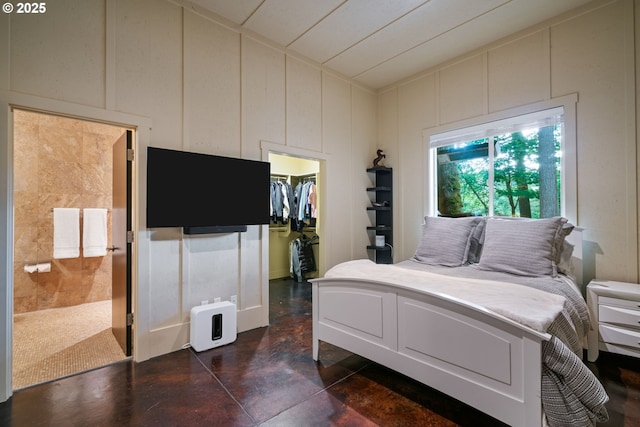 1311 NW 5th Ave, Camas, WA 98607 - bedroom with a decorative wall, a walk in closet, finished concrete flooring, lofted ceiling, and a closet
