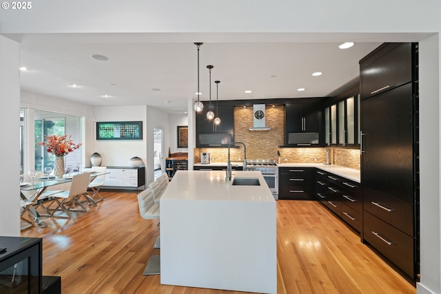 1311 NW 5th Ave, Camas, WA 98607 - kitchen with a sink, dark cabinets, light wood-type flooring, light countertops, and recessed lighting
