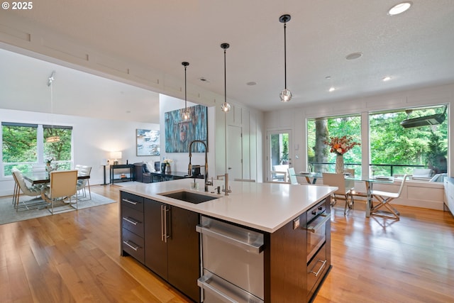 1311 NW 5th Ave, Camas, WA 98607 - kitchen featuring a sink, open floor plan, light wood-type flooring, recessed lighting, and plenty of natural light
