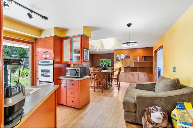 2120 W 23rd Ave, Eugene, OR 97405 - kitchen with stainless steel appliances, stainless steel countertops, plenty of natural light, and light wood-style floors