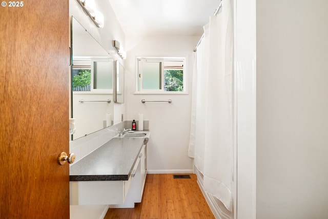 2120 W 23rd Ave, Eugene, OR 97405 - bathroom with vanity, healthy amount of natural light, wood finished floors, and a shower with curtain