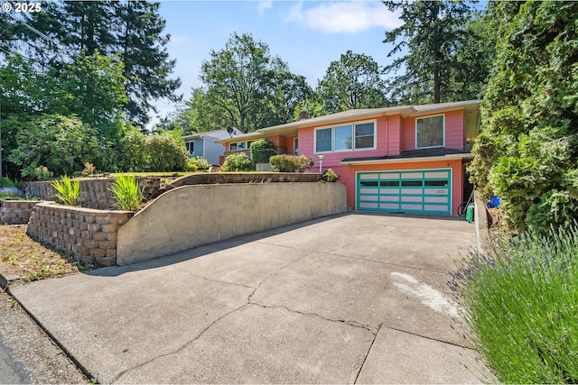 2120 W 23rd Ave, Eugene, OR 97405 - view of front facade featuring concrete driveway, an attached garage, and a chimney