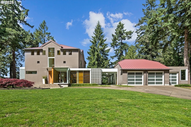 693 Terrace Dr, Lake Oswego, OR 97034 - view of front facade featuring stucco siding, a front yard, driveway, and a metal roof