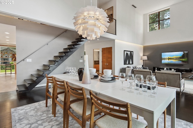 693 Terrace Dr, Lake Oswego, OR 97034 - dining area with stairway, a high ceiling, wood finished floors, a chandelier, and recessed lighting