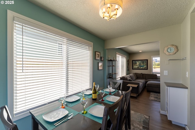 1005 NW Pacific Way, Waldport, OR 97394 - dining area featuring dark wood-type flooring, a textured ceiling, and a chandelier