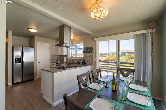 1005 NW Pacific Way, Waldport, OR 97394 - dining space with a textured ceiling, dark wood-style floors, and a chandelier