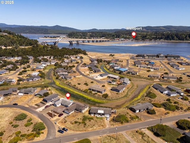 1005 NW Pacific Way, Waldport, OR 97394 - aerial view of property and surrounding area featuring a water and mountain view and a notable bridge