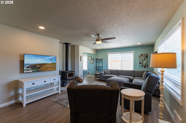 1005 NW Pacific Way, Waldport, OR 97394 - living room featuring a wood stove, a textured ceiling, dark wood finished floors, ceiling fan, and recessed lighting