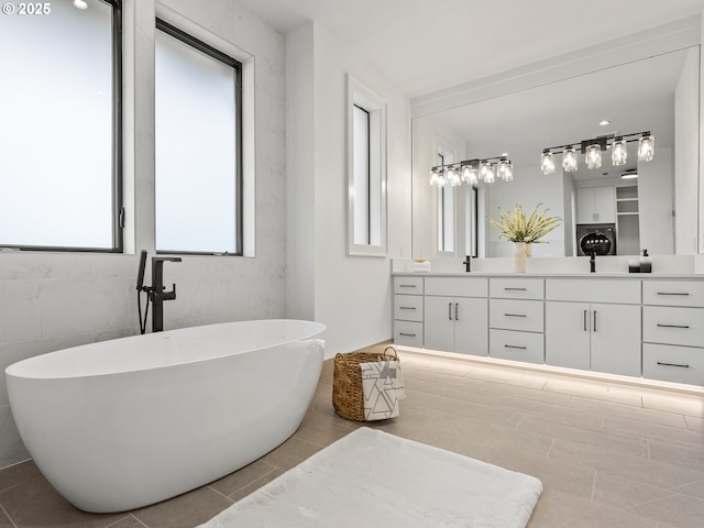 full bathroom featuring tile patterned flooring, double vanity, and a freestanding bath