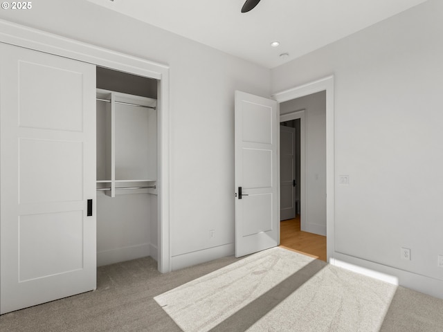 unfurnished bedroom featuring recessed lighting, a closet, baseboards, carpet flooring, and ceiling fan