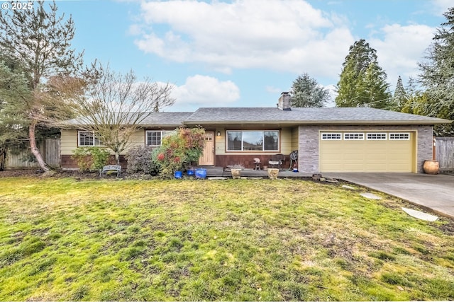 ranch-style home with an attached garage, fence, concrete driveway, and a front yard