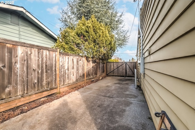 view of patio with a gate and fence