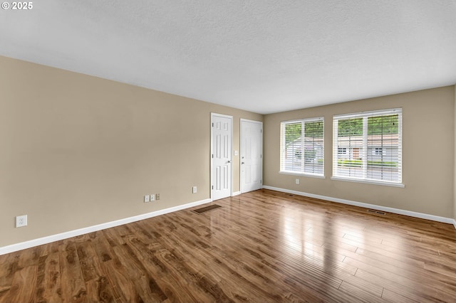 1320 NW Maple Ln, Camas, WA 98607 - unfurnished room with baseboards, wood finished floors, and a textured ceiling