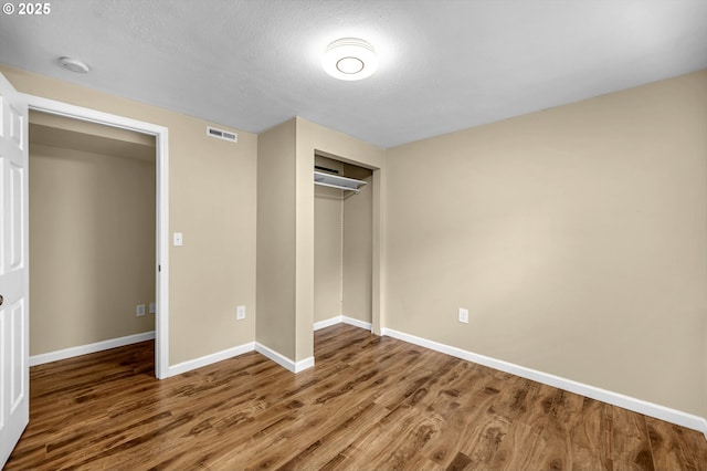 1320 NW Maple Ln, Camas, WA 98607 - unfurnished bedroom with wood finished floors, baseboards, and a closet