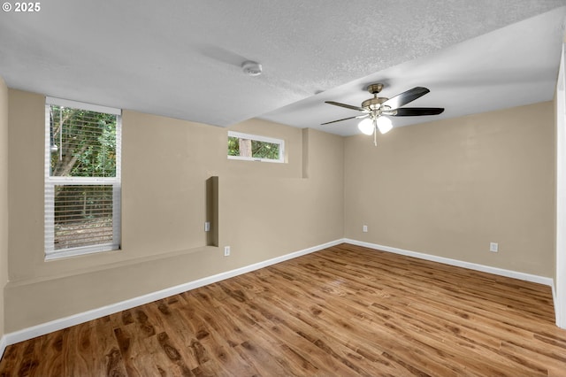 1320 NW Maple Ln, Camas, WA 98607 - empty room featuring plenty of natural light, baseboards, wood finished floors, a textured ceiling, and a ceiling fan