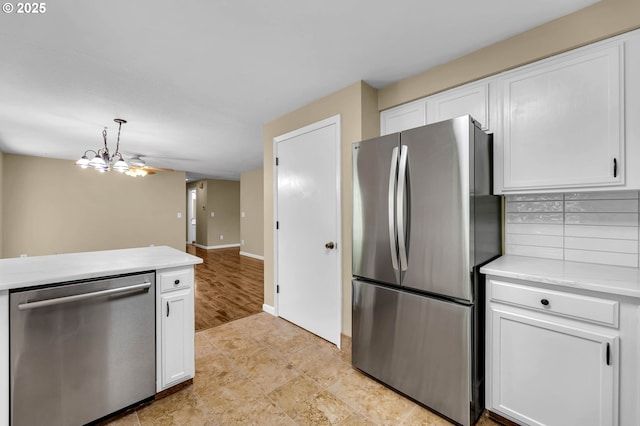 1320 NW Maple Ln, Camas, WA 98607 - kitchen featuring stainless steel appliances, white cabinets, light countertops, and hanging light fixtures