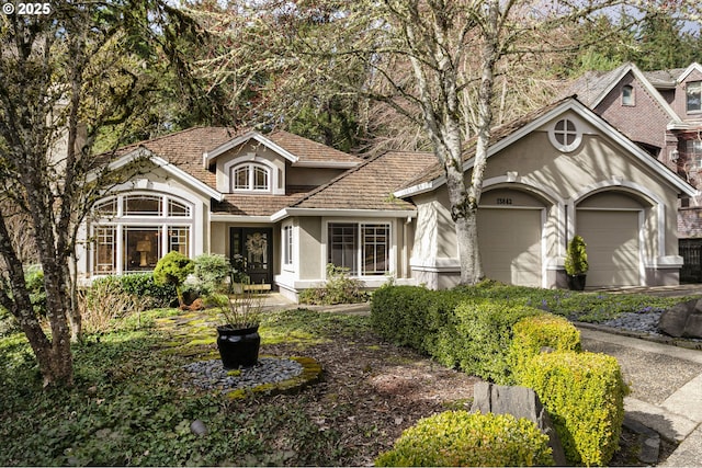 view of front of property featuring an attached garage and stucco siding