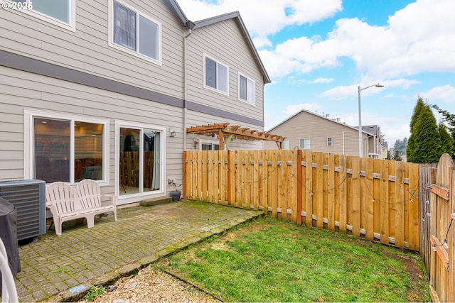 view of yard featuring a patio, central air condition unit, and a pergola