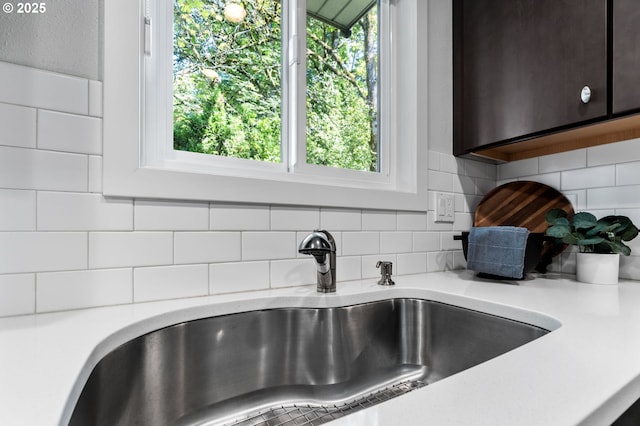 1442 SW 66th Ave, Portland, OR 97225 - kitchen view of light countertops, tasteful backsplash, and dark brown cabinets