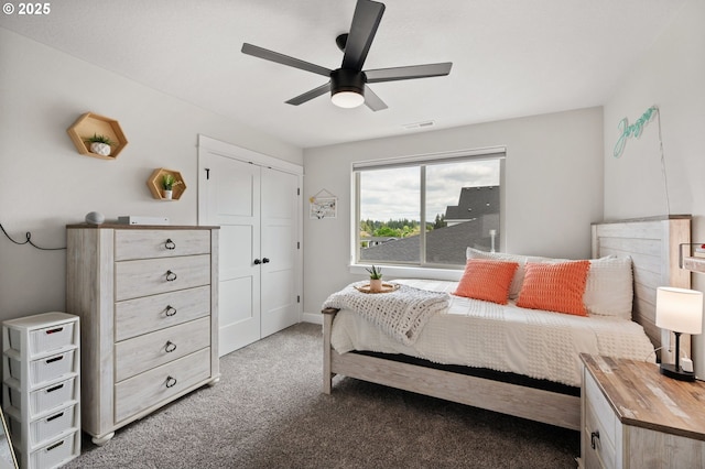 bedroom featuring visible vents, a ceiling fan, carpet floors, and a closet