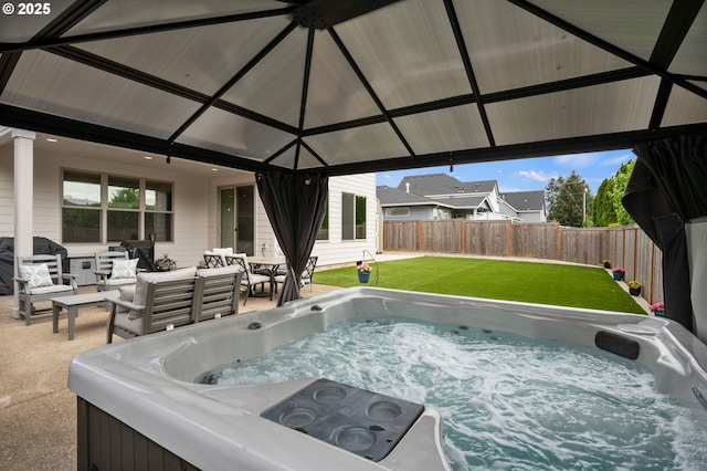 view of swimming pool featuring an outdoor living space, a hot tub, and a fenced backyard