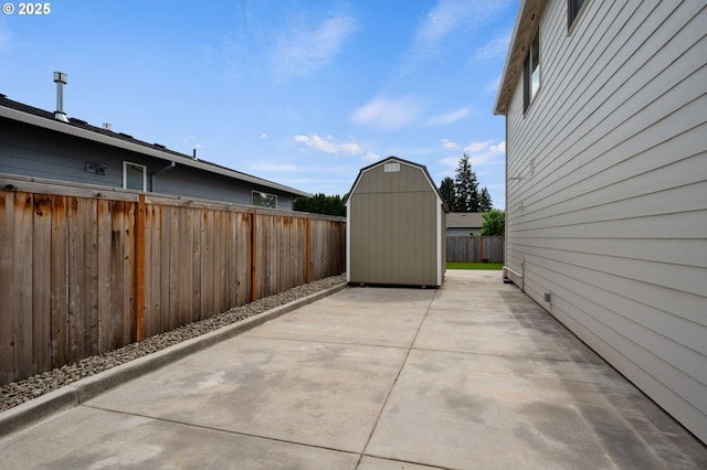 view of patio / terrace featuring a fenced backyard, an outbuilding, and a shed